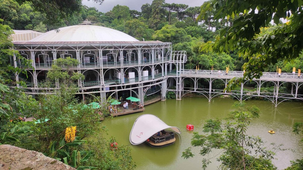 A large, multi-level structure with a dome, surrounded by water and greenery. 3