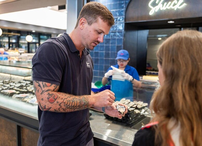 A sushi bar with a man preparing sushi and a child in the background. 5