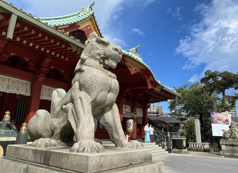 A stone lion statue in front of a traditional Chinese building with a green roof. 3