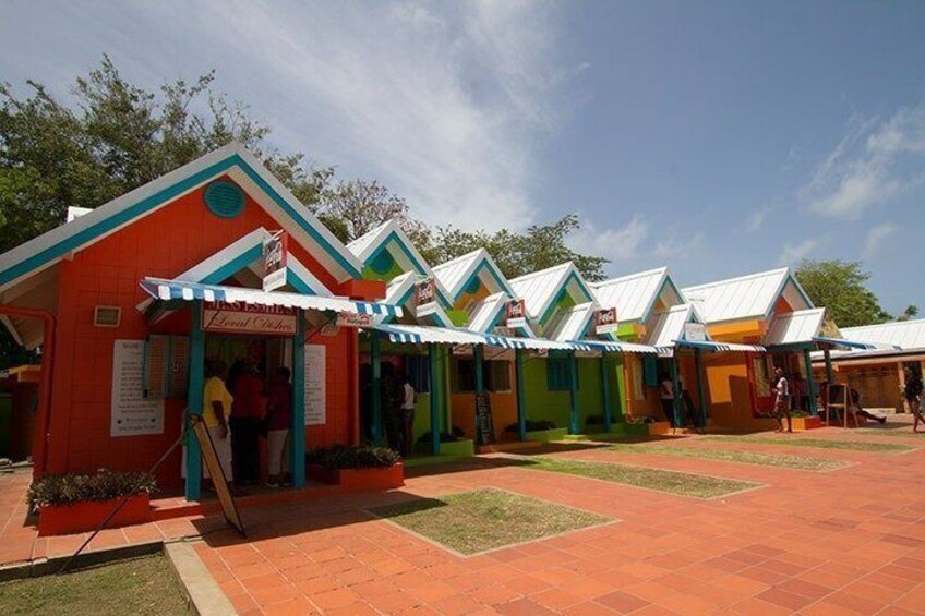 Colorful buildings with awnings, a paved area, and a clear sky. 3
