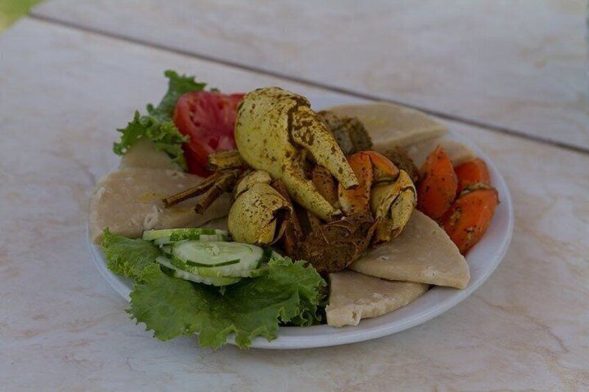 A plate of food with grilled crab, vegetables, and a slice of bread. 2