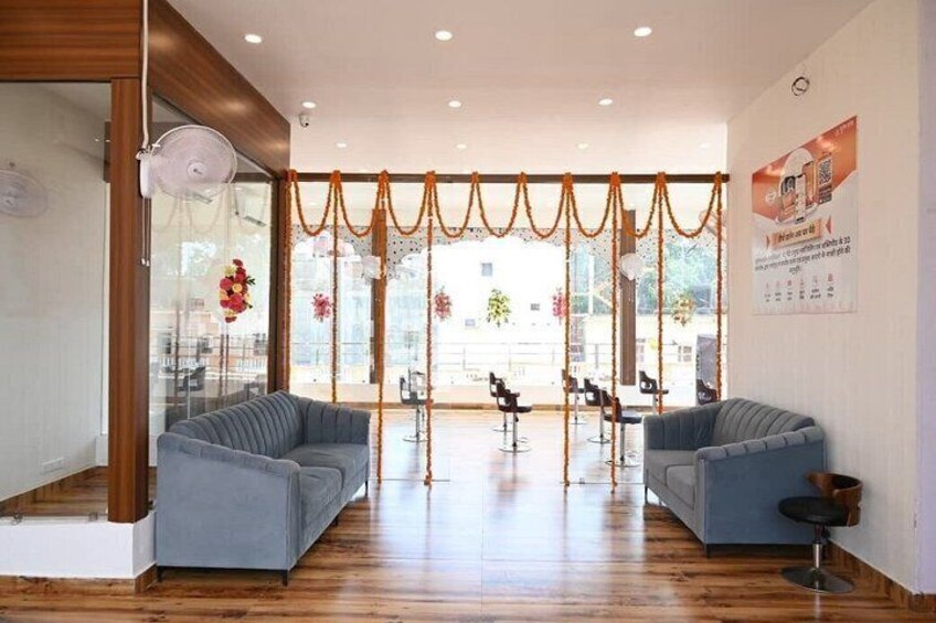 A modern interior with two grey sofas, a wooden floor, and a glass door leading outside. 4