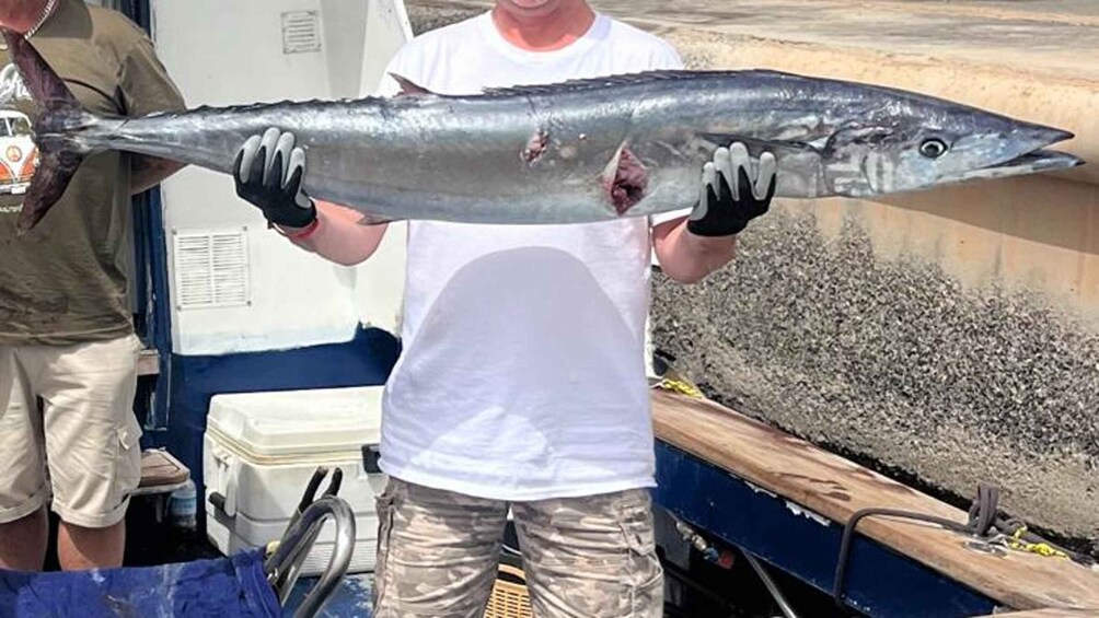 A person holding a large fish. 2