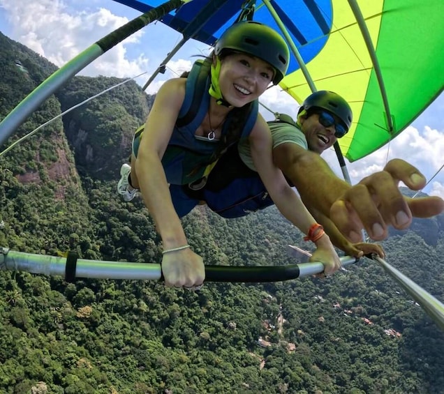 Two people bungee jumping with a parachute, surrounded by a mountainous landscape. 3
