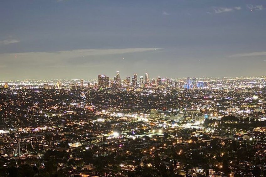 A cityscape at night with illuminated buildings and streets. 2