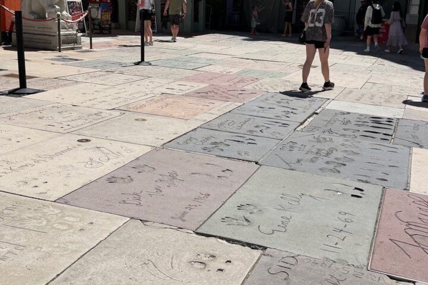 A public square with a mosaic of tiles, some with inscriptions. 4