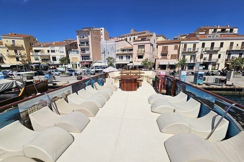 A marina with boats, a pool with lounge chairs, and buildings in the background. 4