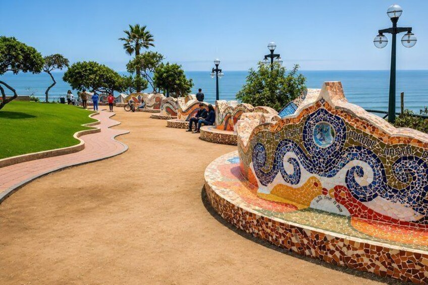 A mosaic pathway, palm trees, and a view of the sea. 3