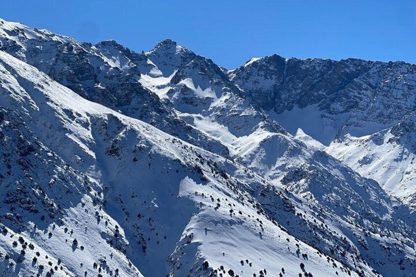 A snow-covered mountain range with rugged peaks and deep valleys. 5
