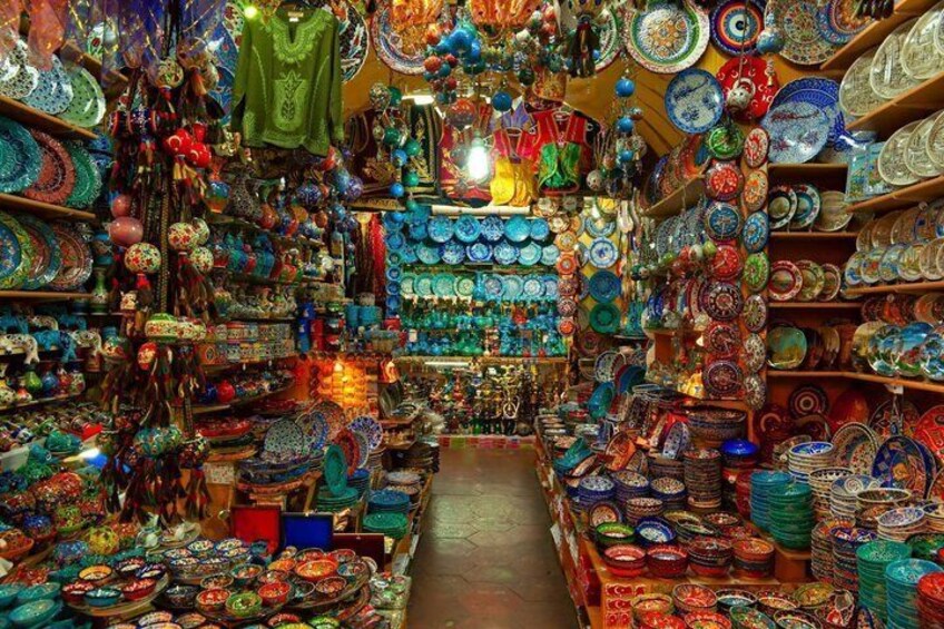 A vibrant market with colorful ceramic plates and bowls on display. 5
