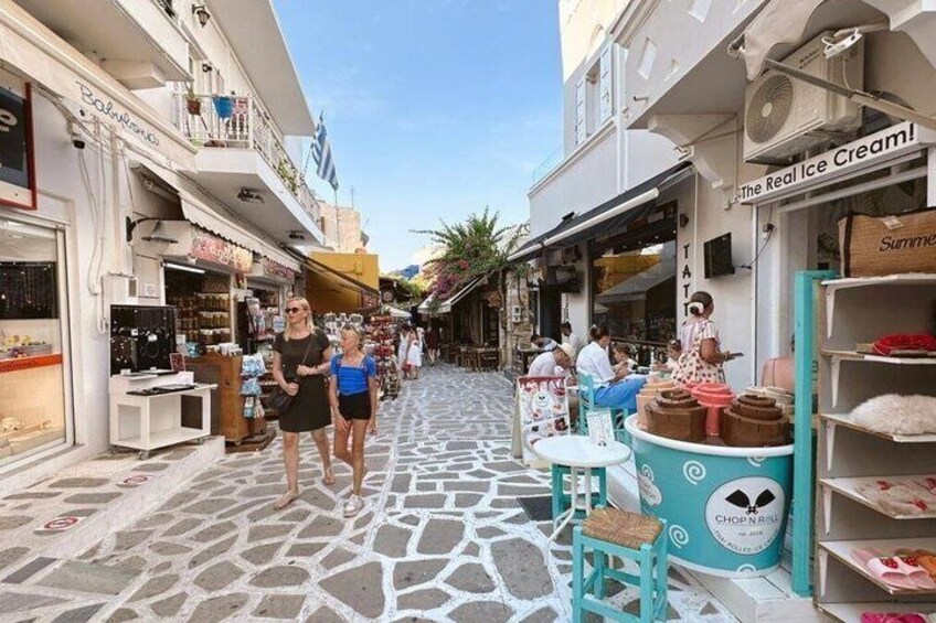 A narrow street with shops, a café, and a sign for 'The Real Ice Cream.' 5