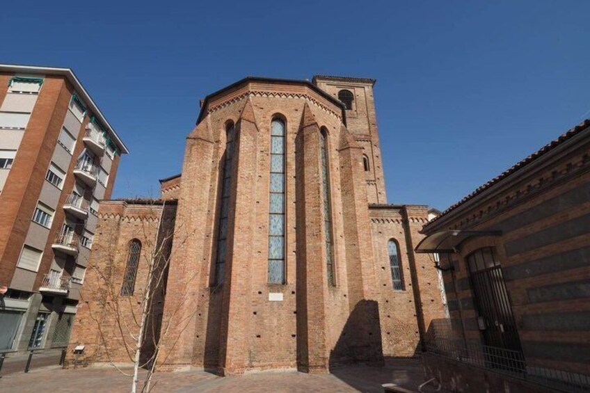 A historic brick church with tall arched windows and a bell tower. 3
