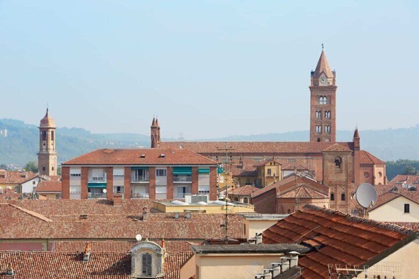A historic town with a prominent church featuring a bell tower and a large dome. 1