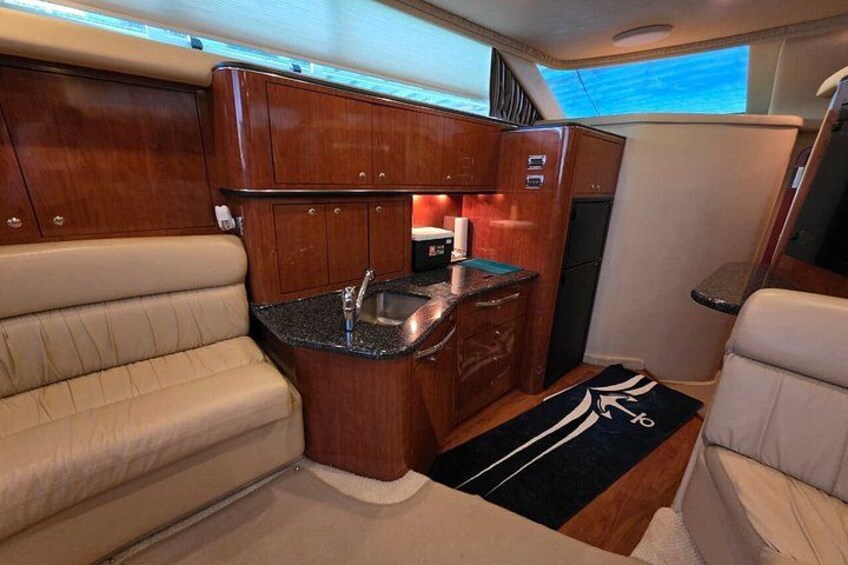 A compact kitchen with wooden cabinets, a sink, and a countertop. 4
