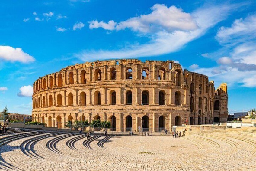 An ancient amphitheater with a clear sky. 1