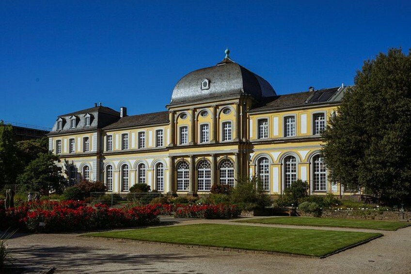 A large, historic building with a prominent dome and symmetrical architecture. 1