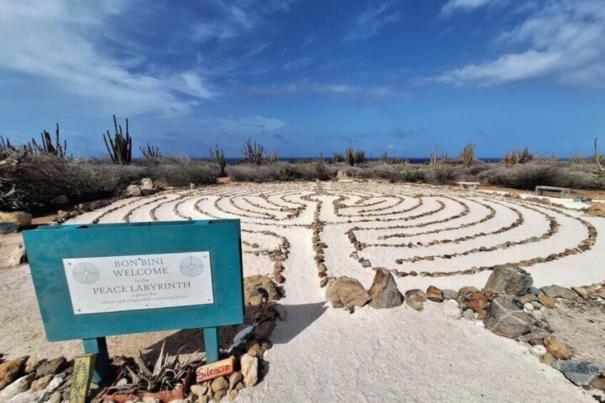 A labyrinth with a sign reading 'BONBINI WELCOME to the PEACE LABYRINTH.' 5