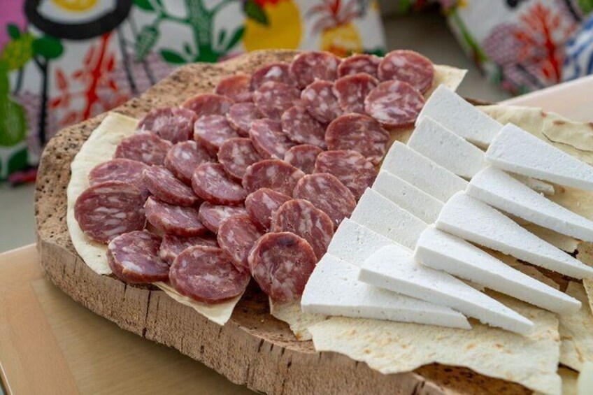 Sliced salami and cheese on a wooden board. 4