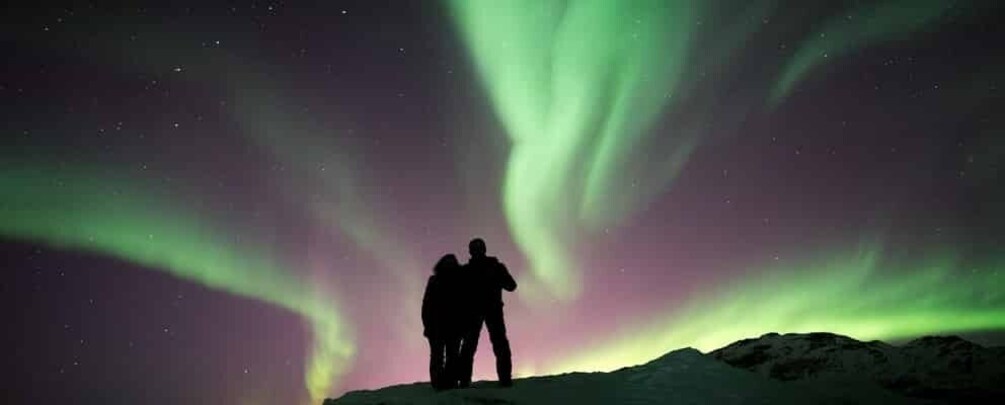 Two people observing the Northern Lights. 4