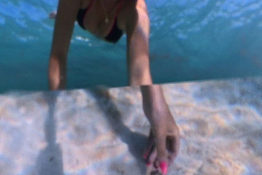 A person in a swimsuit near a pool edge. 5
