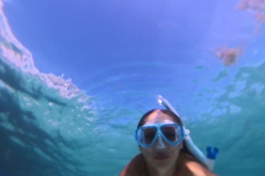 A person snorkeling underwater with a snorkel and mask. 3