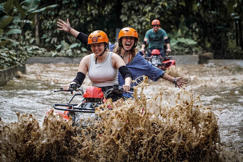 People on a watercraft navigating through a river with splashing water. 1