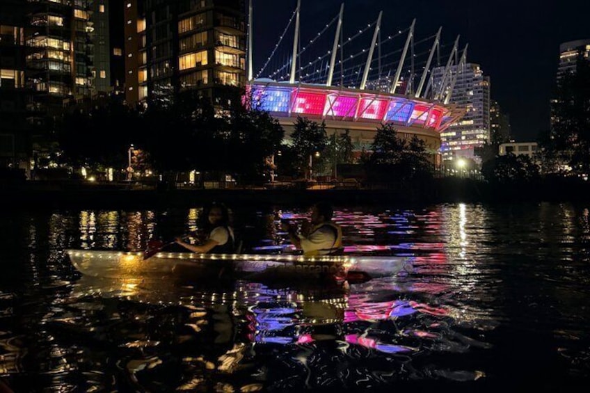 A nighttime river scene with a brightly lit building in the background. 3