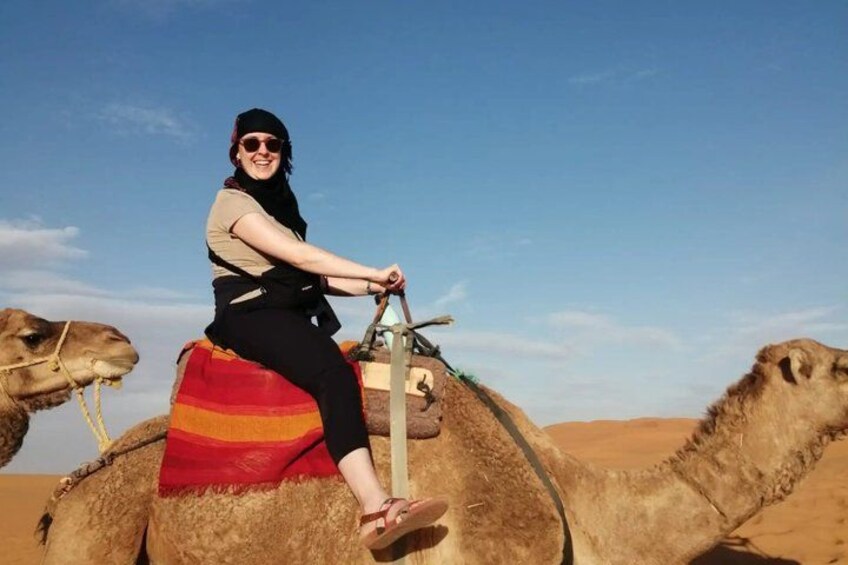 A person riding a camel in a desert landscape. 4