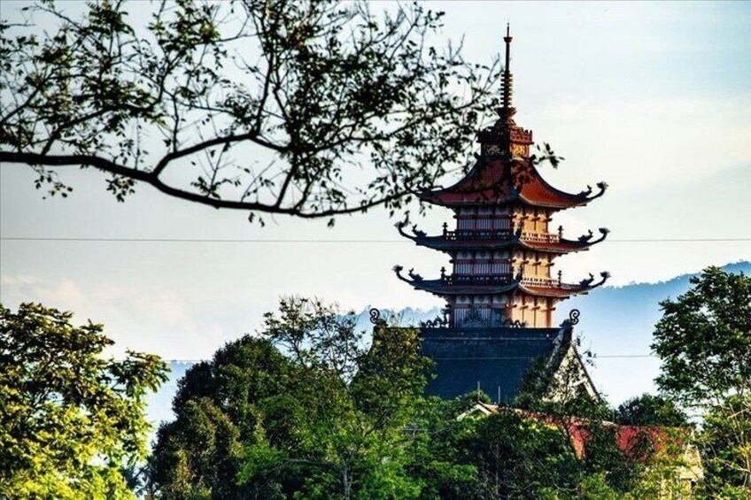 A traditional multi-tiered pagoda surrounded by lush greenery. 2