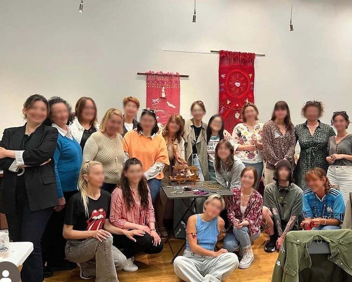 A group of people in an indoor setting with red tapestries on the walls. 5