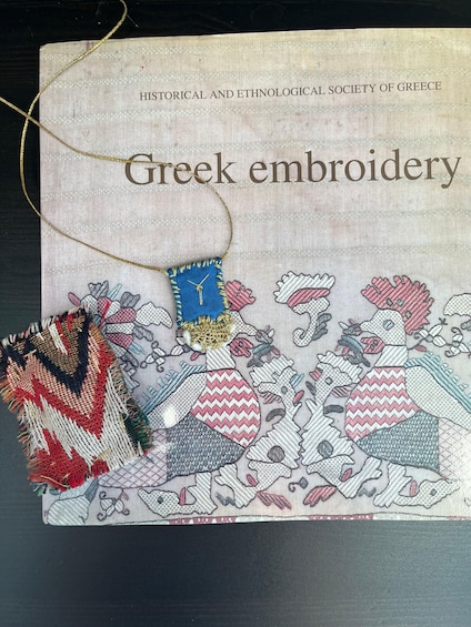 A book titled 'Greek embroidery' with a cover illustration of embroidered patterns. 2