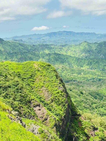 A mountainous landscape with lush greenery and a clear sky. 3