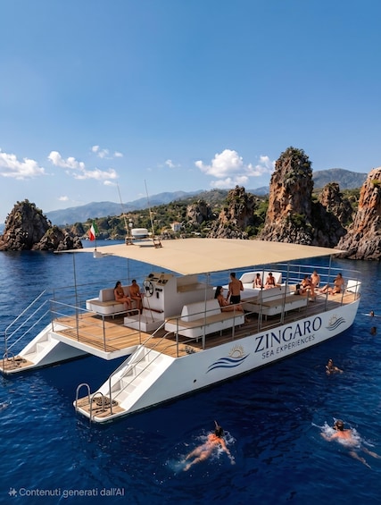 A boat named ZINGARO with people on deck and in the water. 1