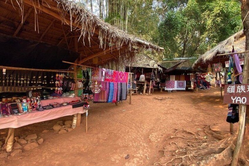 A rural market with stalls selling textiles and crafts. 5