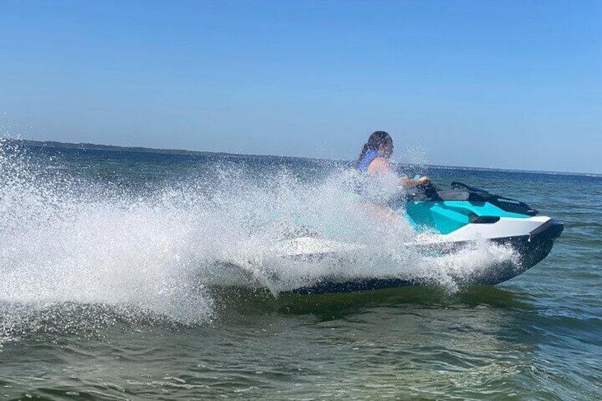 A person jet-skiing on a body of water. 2