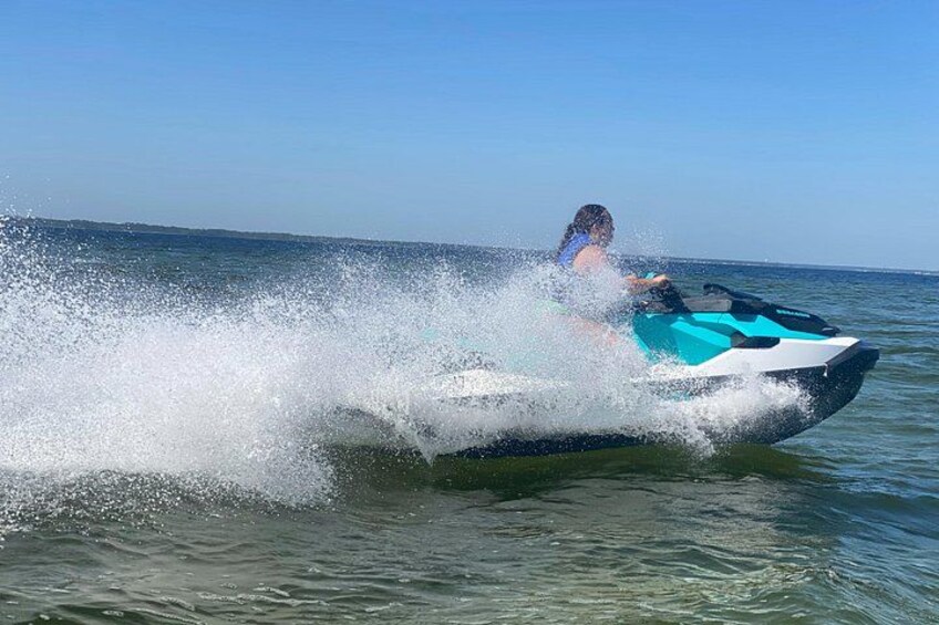 A person riding a jet ski on a body of water. 2