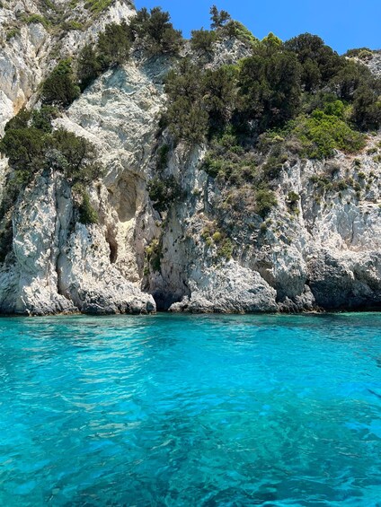 A coastal cliff with clear turquoise water. 4