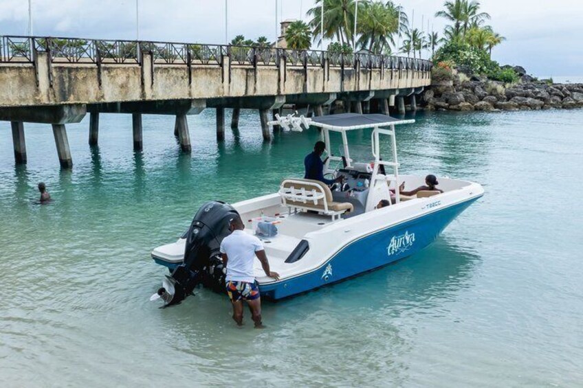 A boat docked at a pier with a bridge in the background. 2
