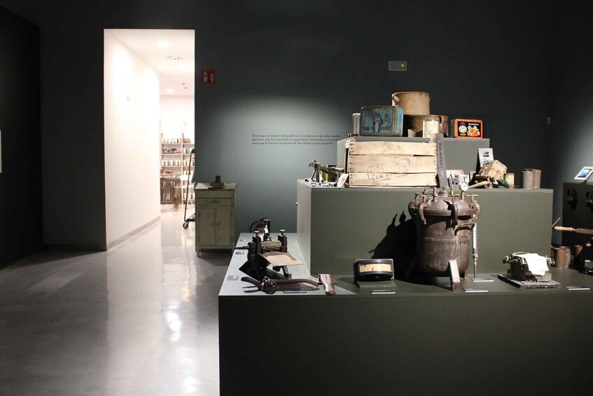 An indoor museum exhibit with historical artifacts and a display case. 1