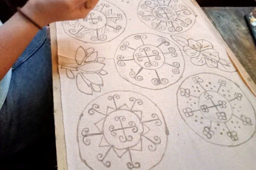 A hand drawing on a paper with circular patterns and floral designs. 2