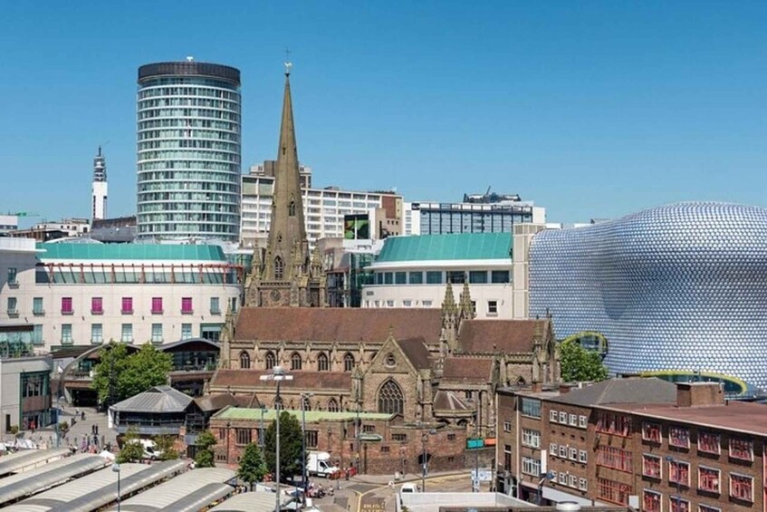 A historic church with a tall spire, a modern cylindrical building, and a distinctive dome-shaped structure. 5