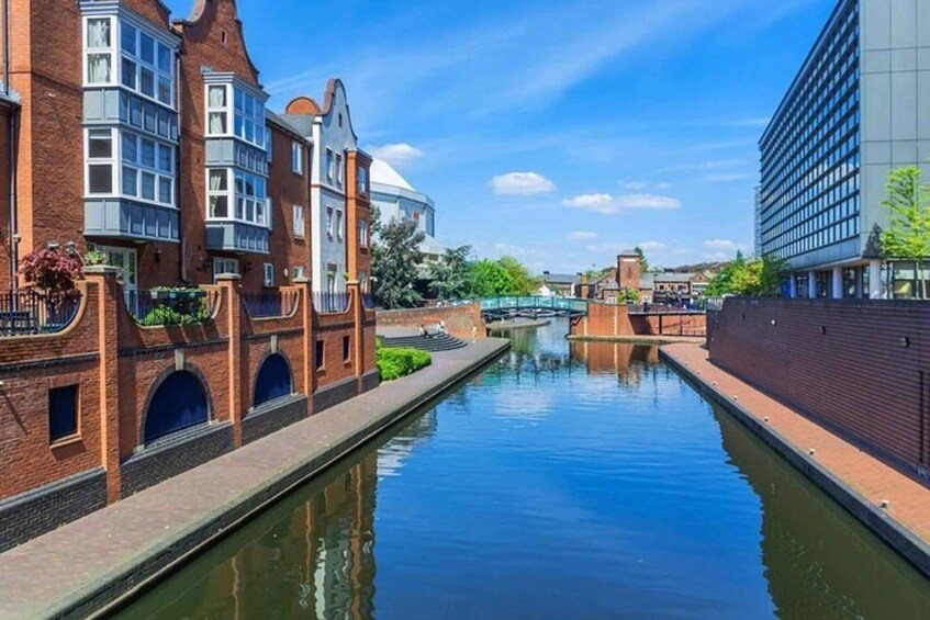 A canal with brick buildings, a dome structure, and a modern building. 3