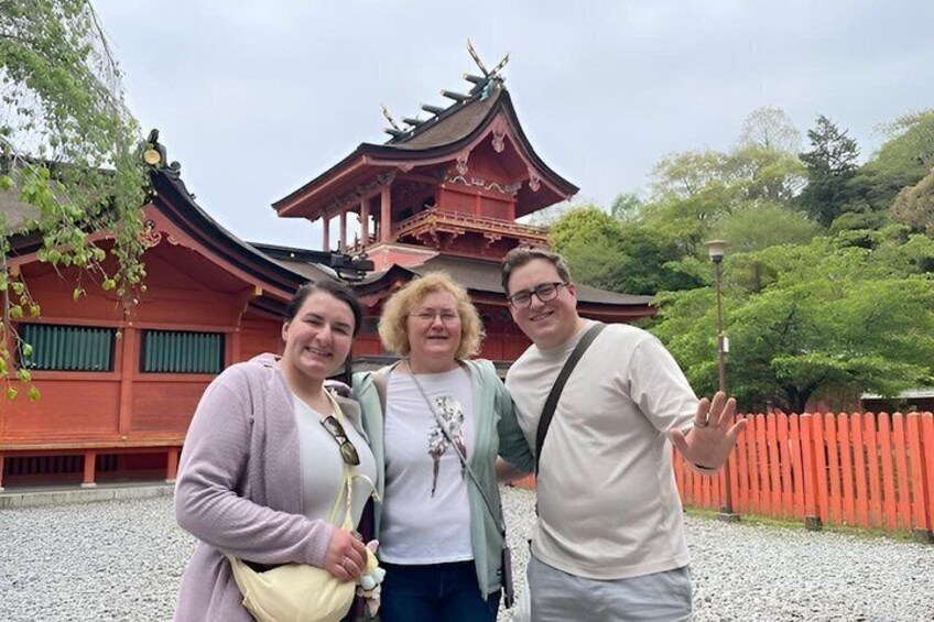 A traditional Japanese building with a curved roof and red walls. 4