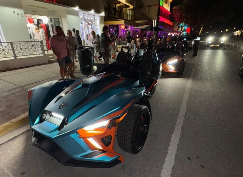 A futuristic sports car parked on a city street at night. 3