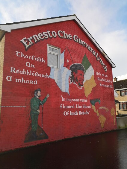 A mural on a building with a map of Ireland and a quote about Irish rebels. 3