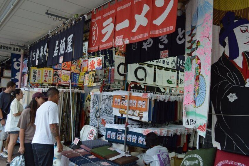 A market stall with various textiles and fabrics on display. 3