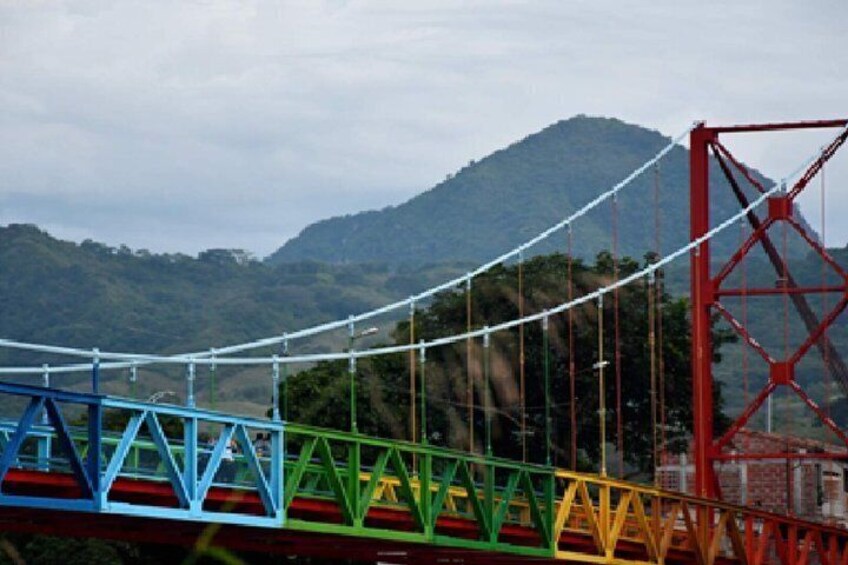 A colorful suspension bridge with a mountainous backdrop. 4