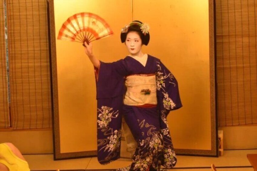 A person in traditional Japanese attire with a fan. 5