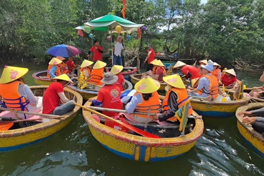 People in canoes on a river, wearing life jackets and conical hats. 5