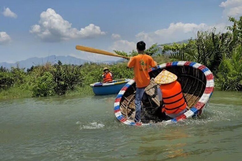A person paddling a boat with a colorful, circular design. 3